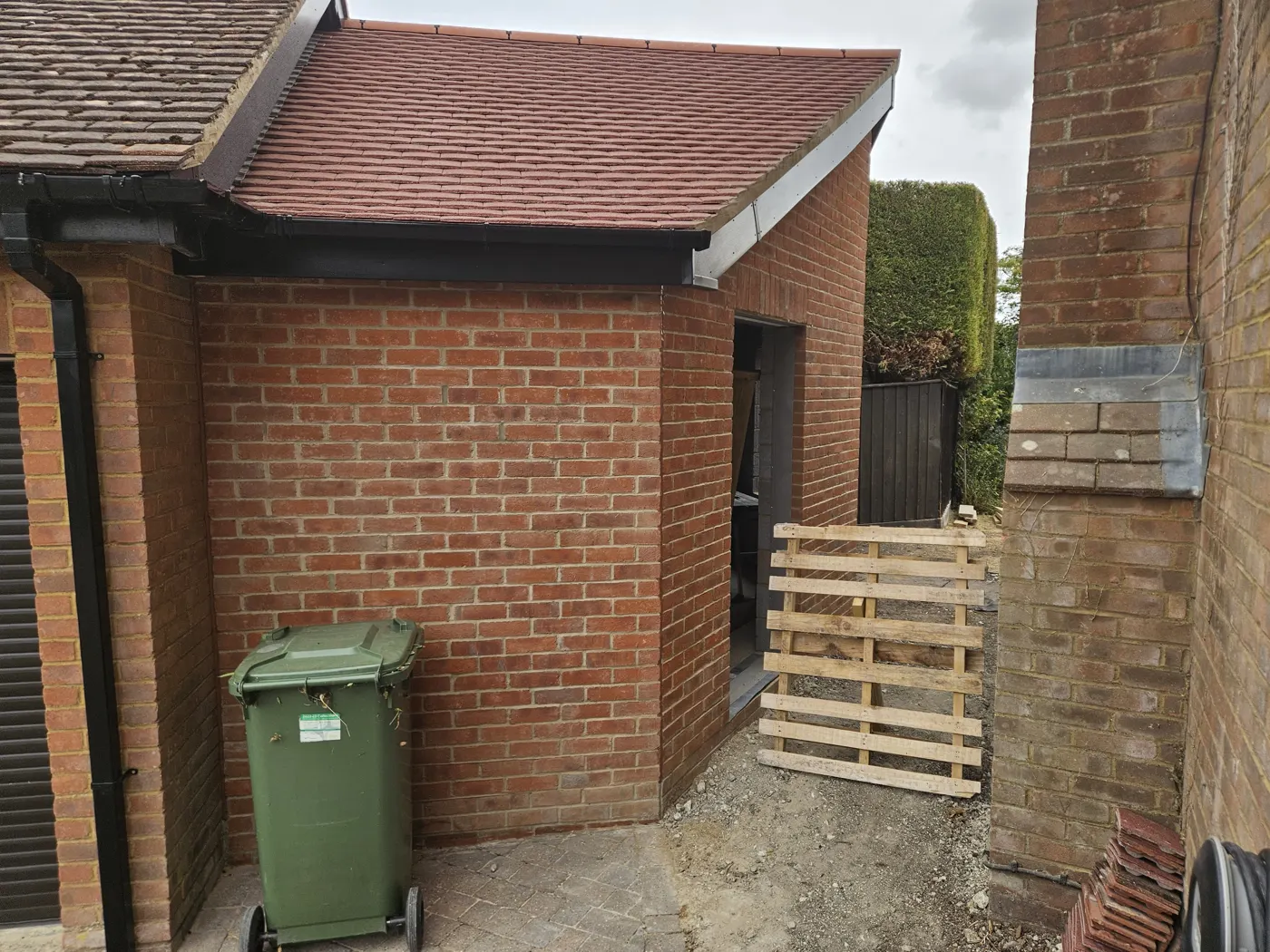 The new outbuilding beside the house showing the matched brick