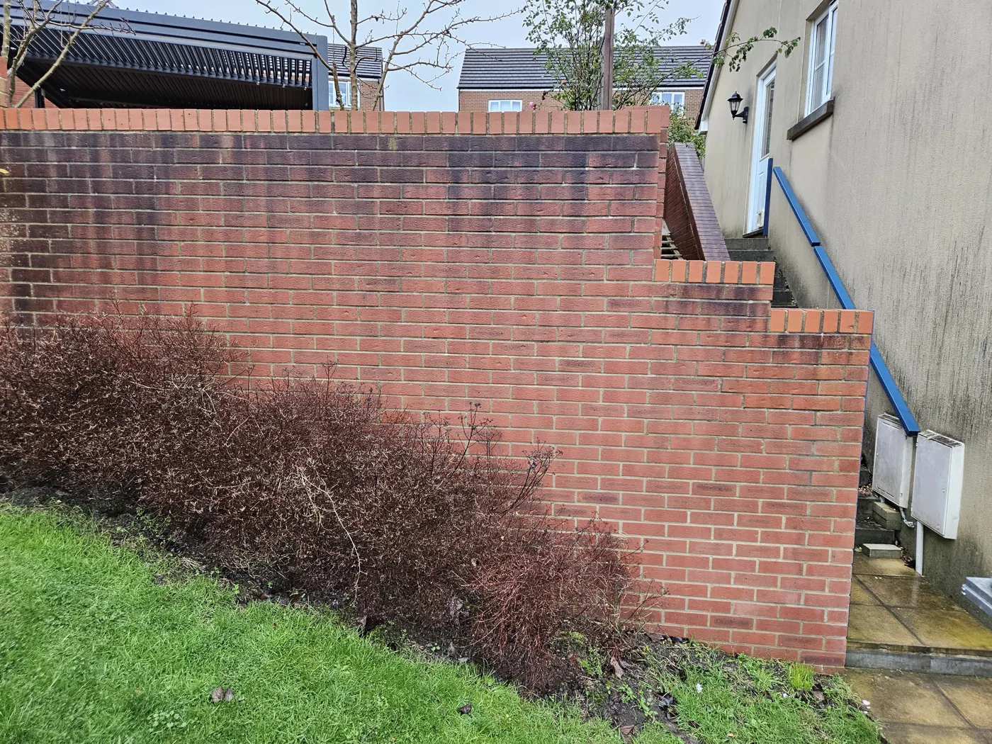 The existing brick boundary wall before rebuilding