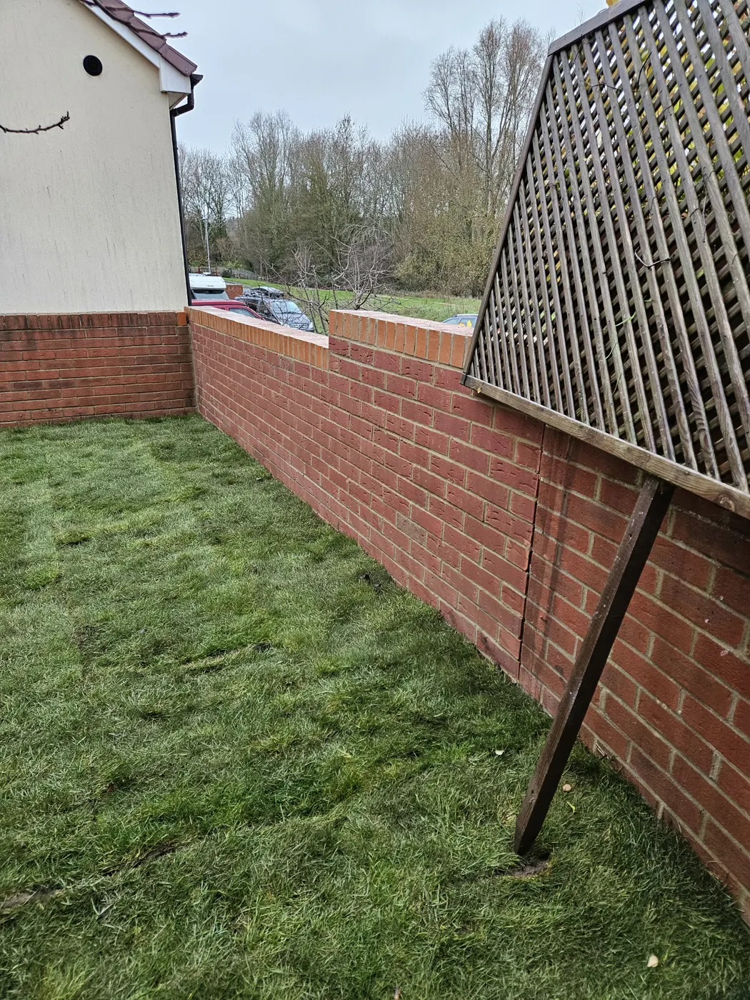 Finished brick boundary wall with the lawn reinstated