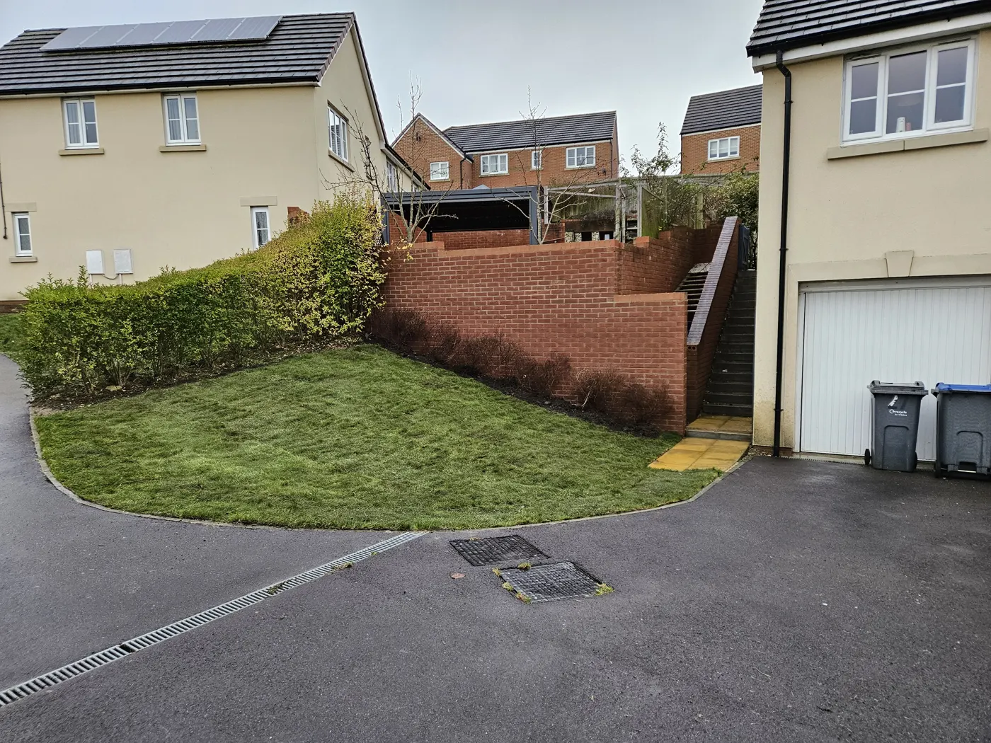 Rebuilt brick garden boundary wall and lawn on Hyde Road, Royal Wootton Bassett