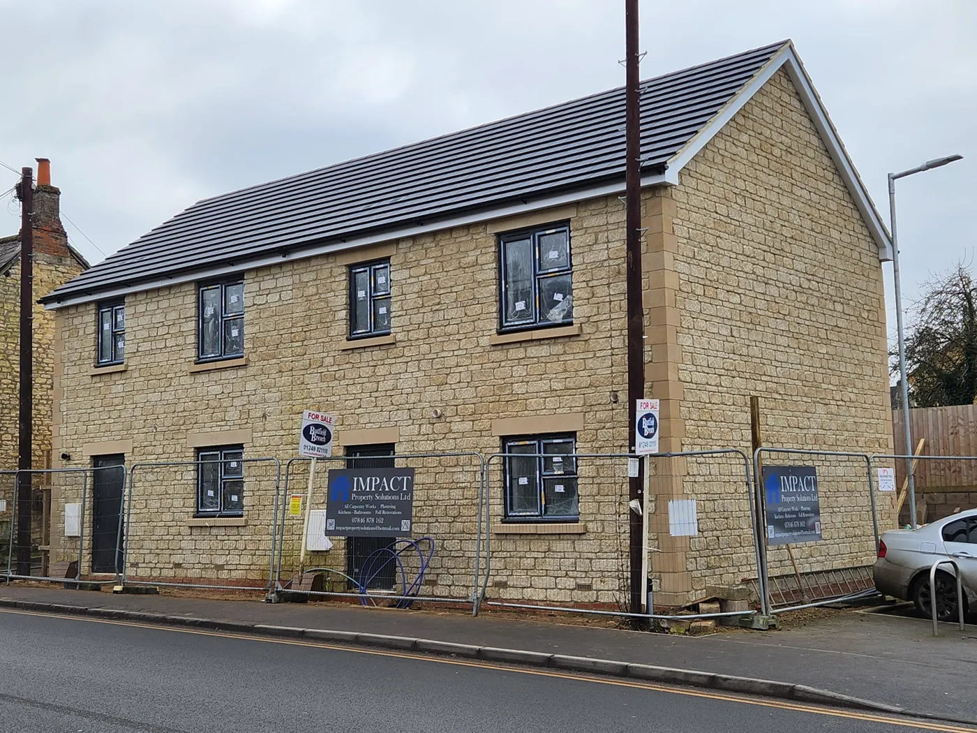 The completed pair of stone-faced semi-detached houses on London Road, Calne