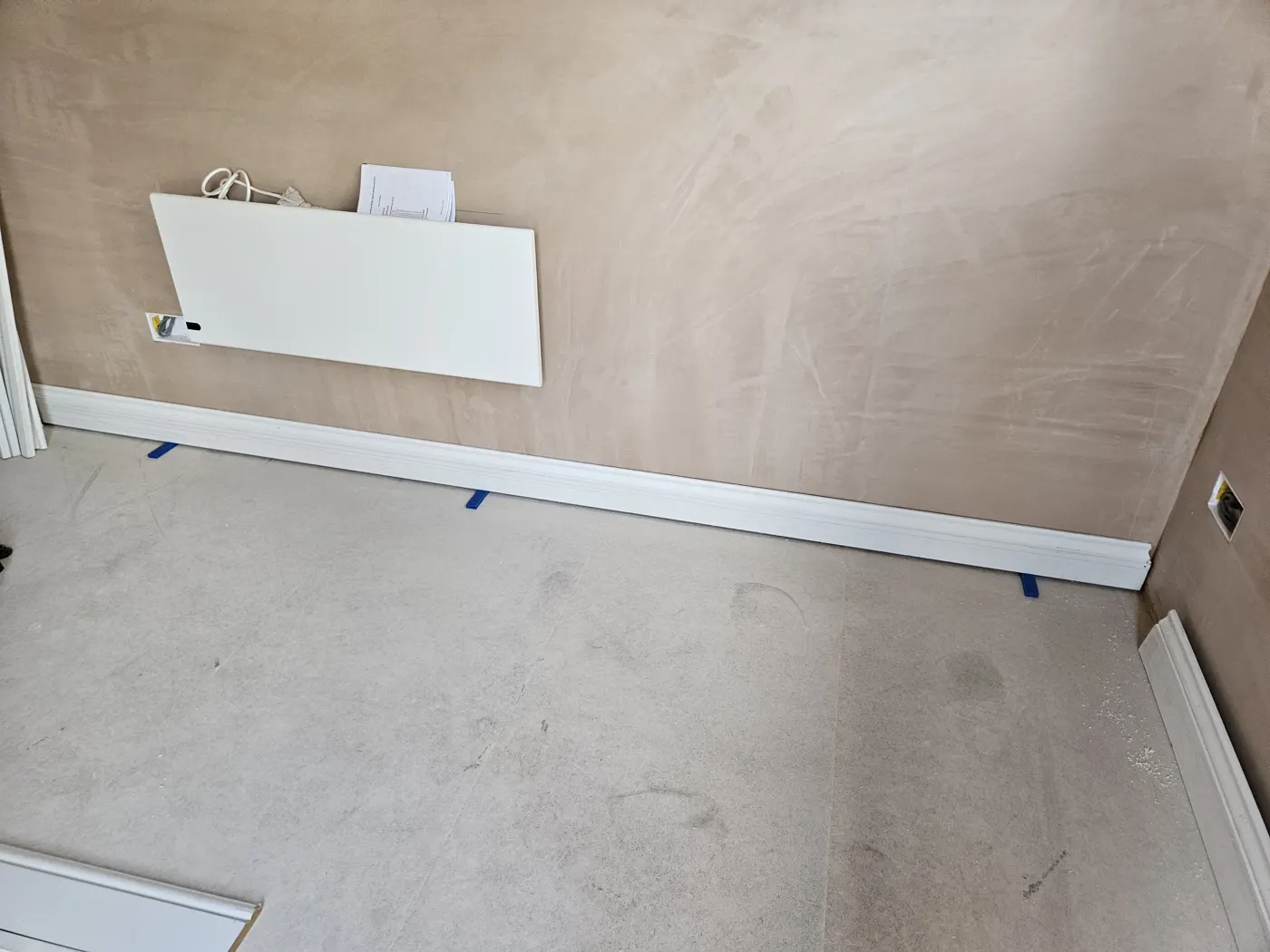 Freshly plastered wall and skirting inside the converted garage