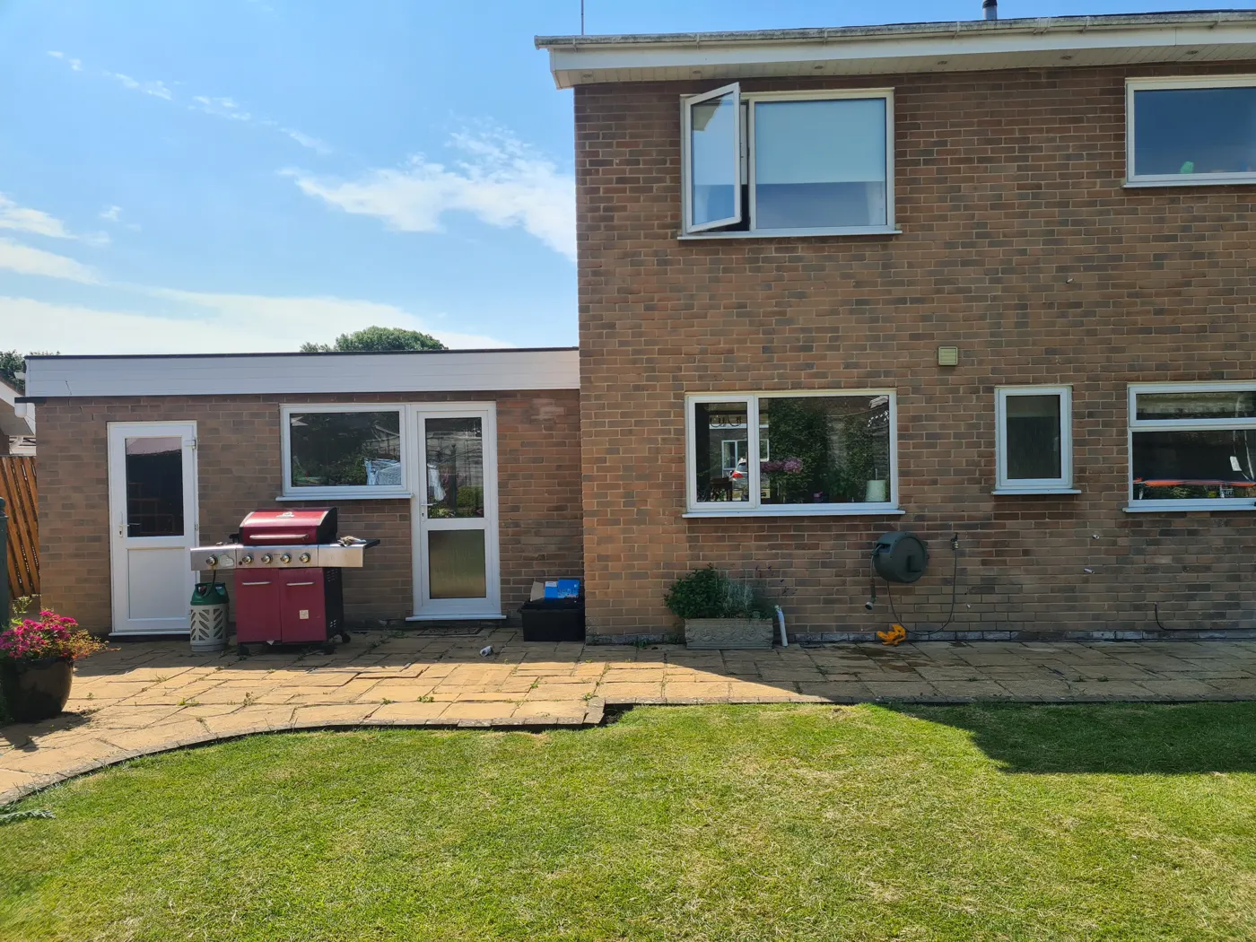 The rear of the 1960s house in Liden before the extension, with the original patio and lawn