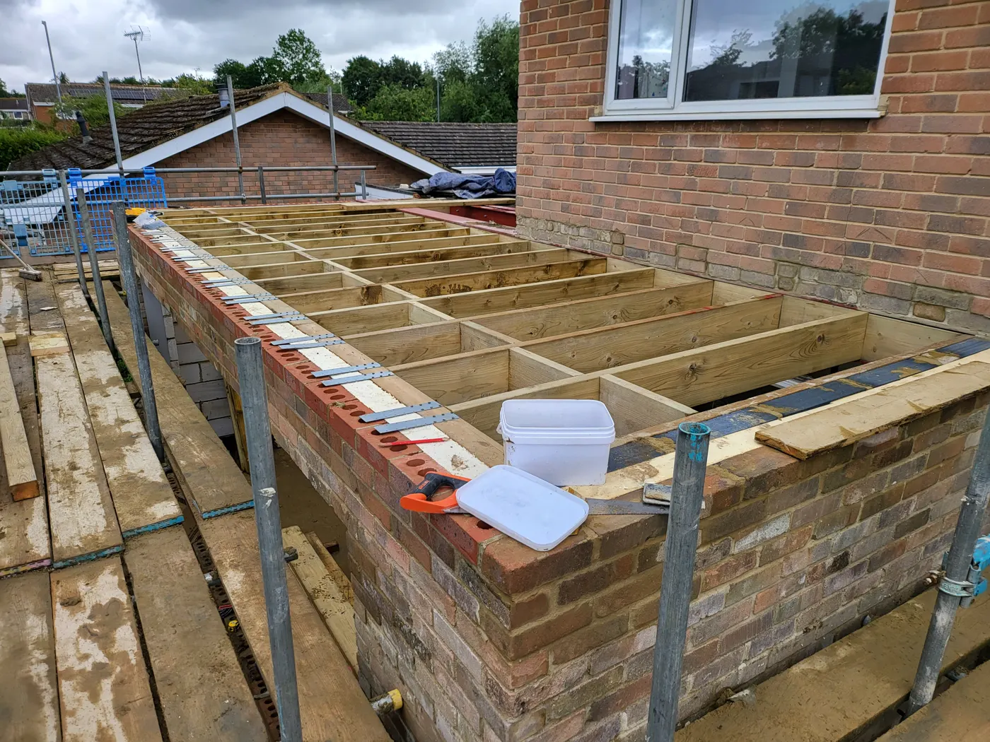 New timber roof joists over the extension with the house wall behind