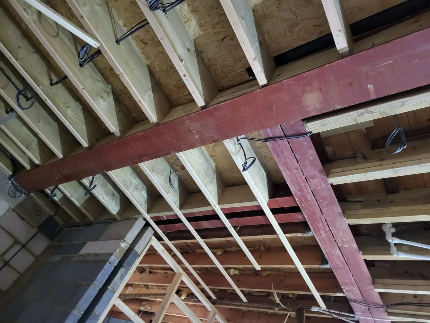 Steel beam and timber roof structure seen from below