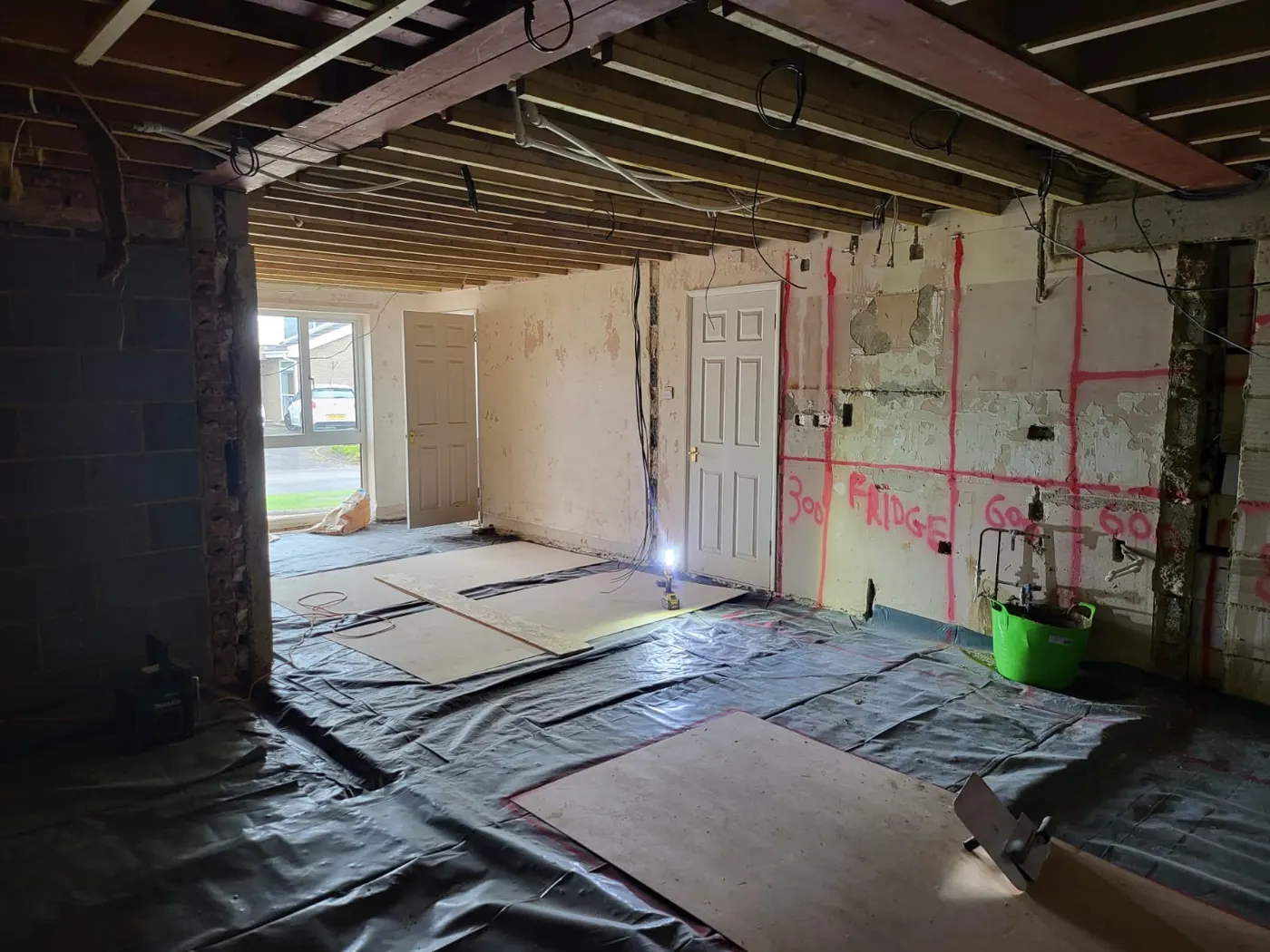 Interior at first-fix stage with stud partitions and services before plastering