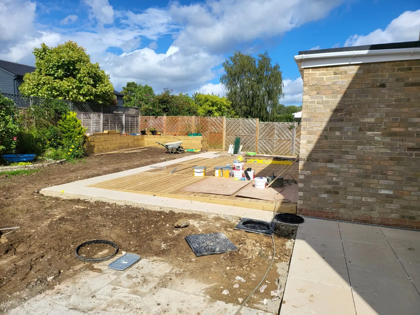 New porcelain patio and timber decking being laid behind the extension