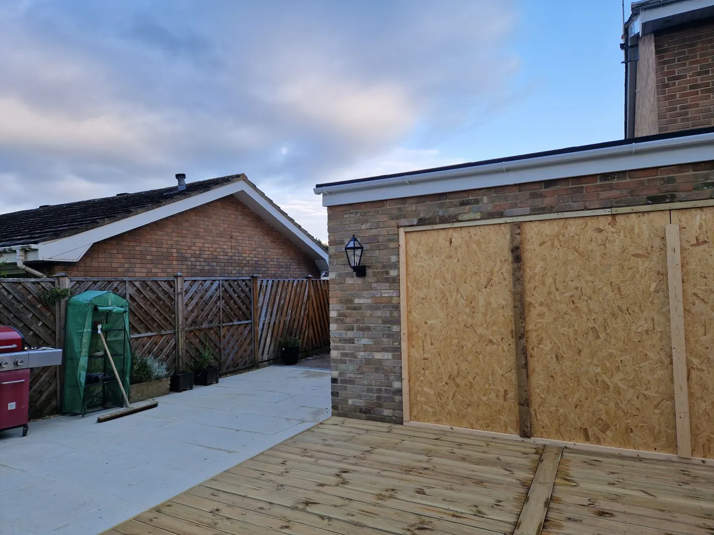 The finished rear extension with patio and decking from the garden