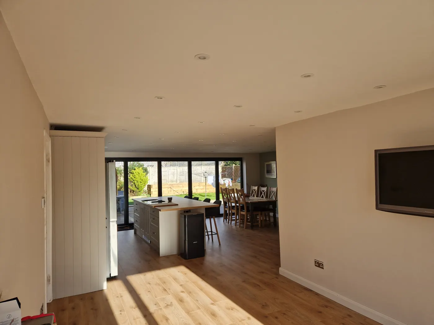 Finished kitchen with island and tiled splashback in the new extension