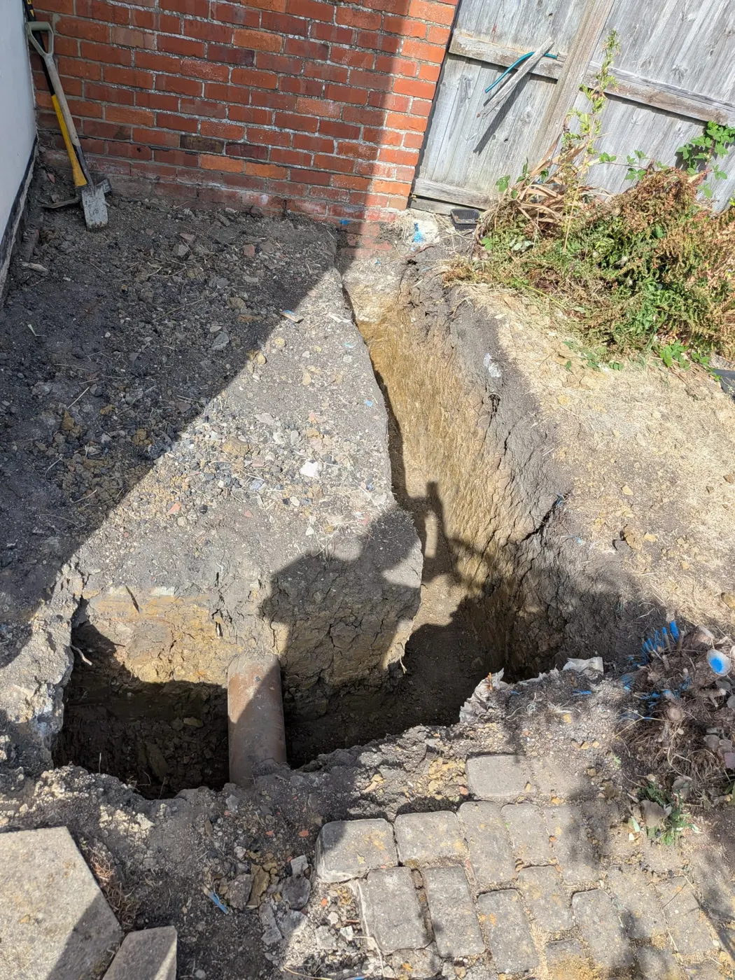 Foundation trench being excavated behind the house