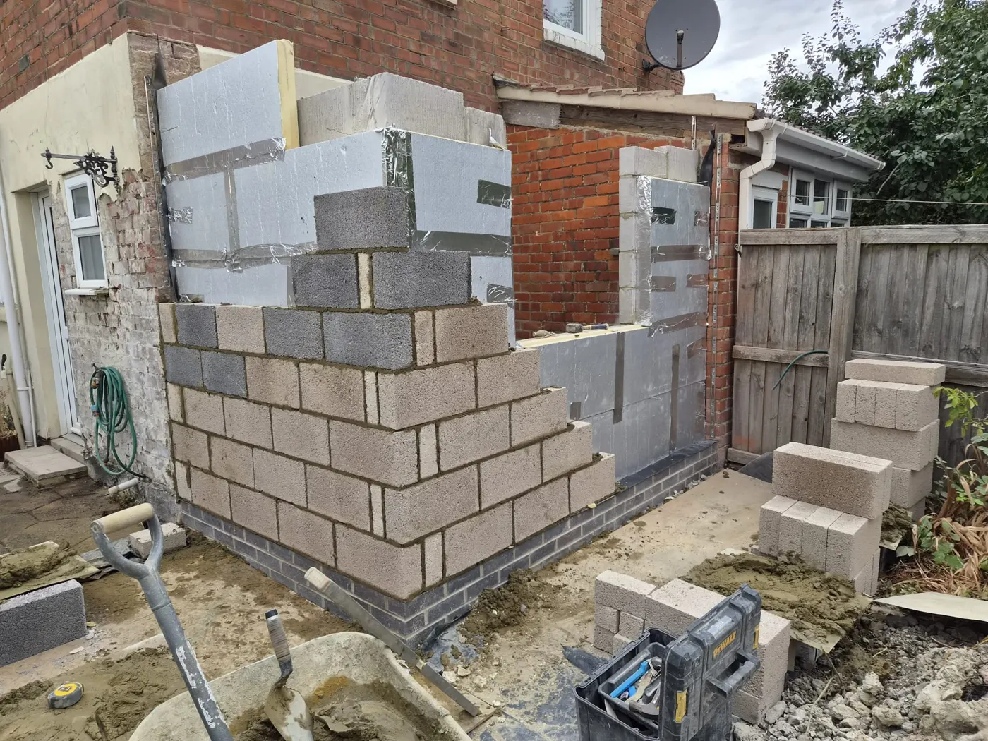 Full-fill cavity insulation between the two leaves of blockwork