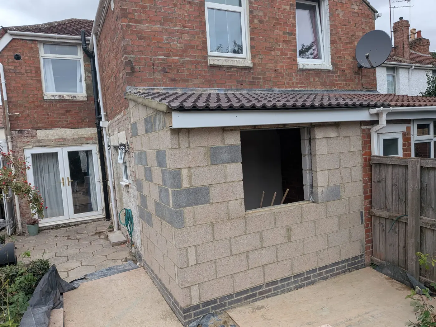 Extension walls at full height with a lintel over the opening into the house