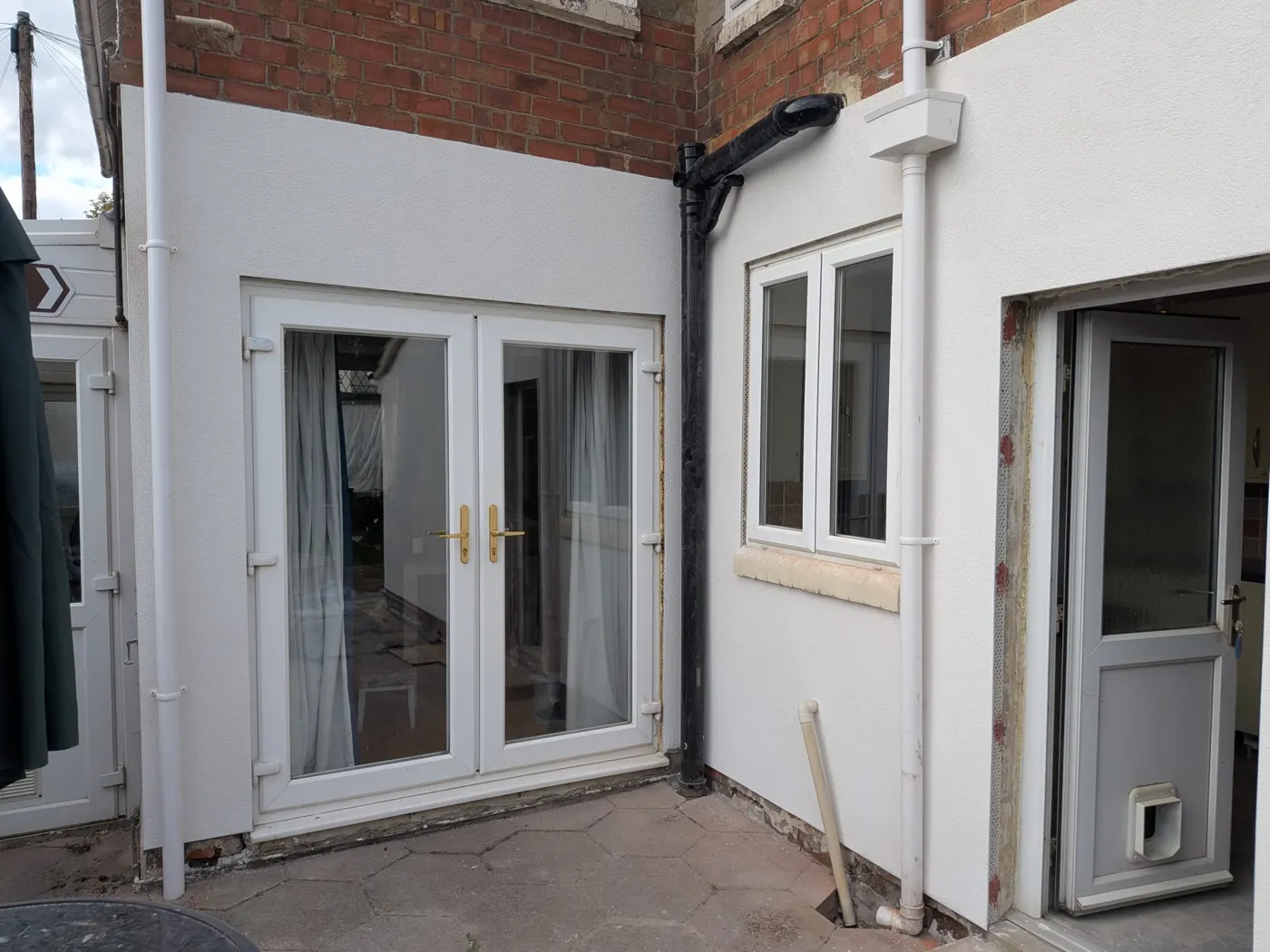 Finished French doors and rendered walls of the extension