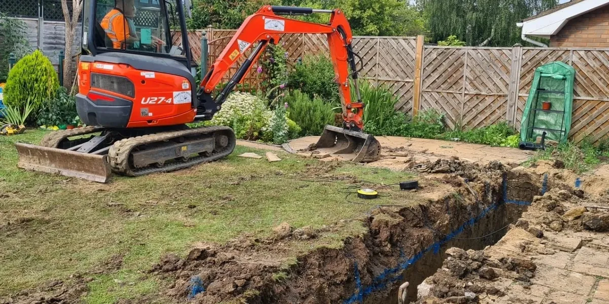 Mini digger excavating a Swindon garden for a new patio and landscaping