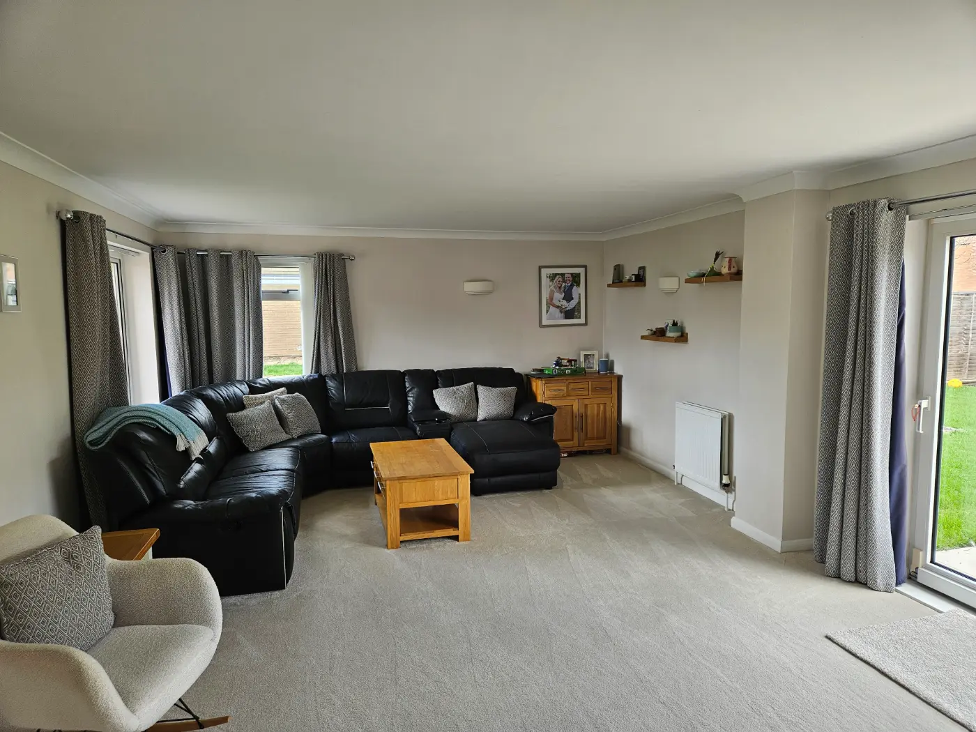 Finished living room after a full renovation in Swindon, replastered and redecorated with new carpet and patio doors