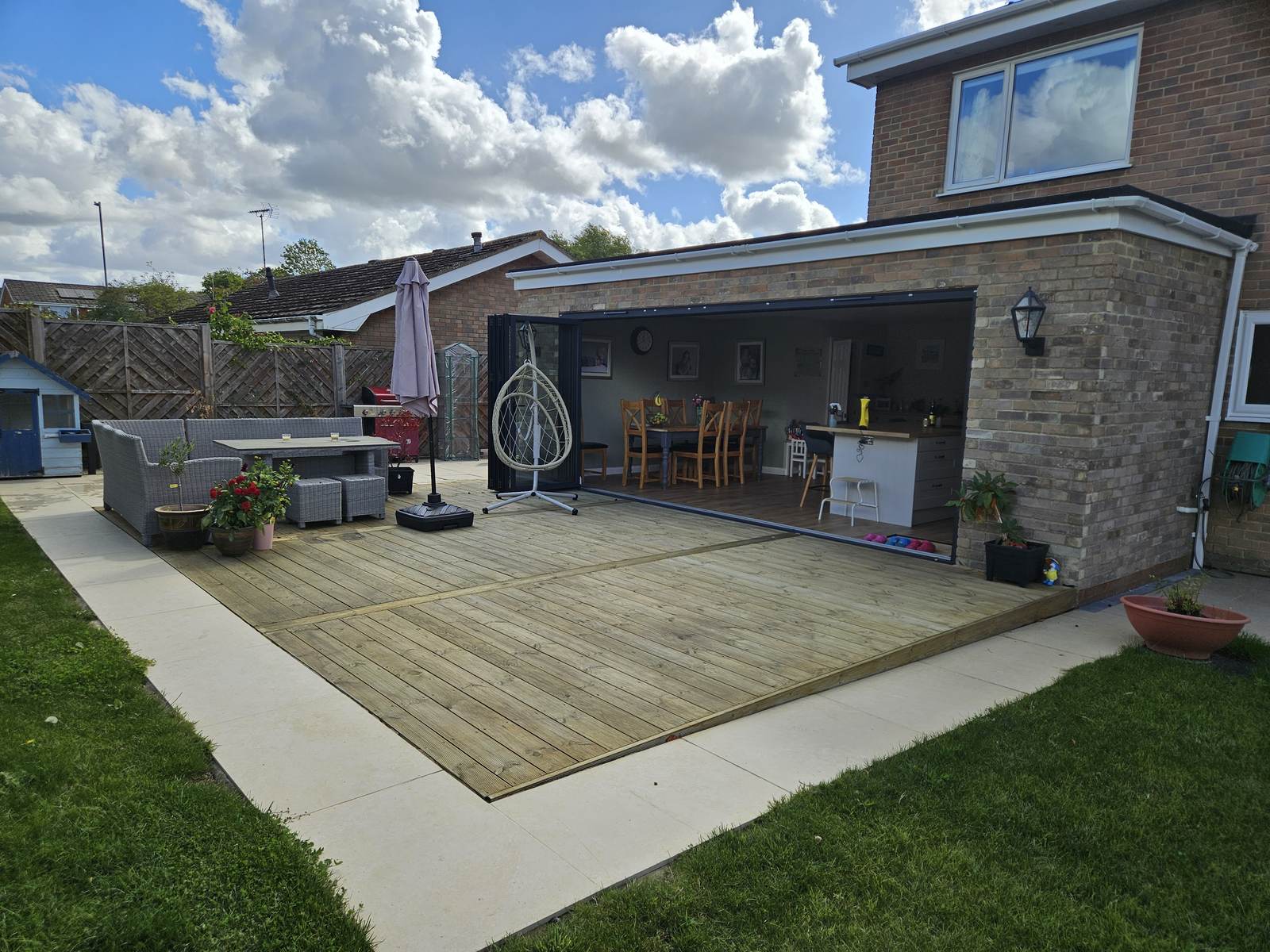 Completed single-storey rear house extension in Swindon with bifold doors and new decking